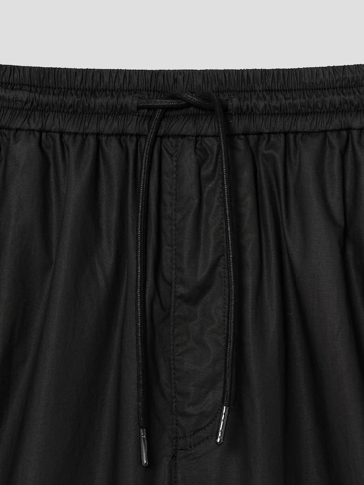 PANTALONES ANCHOS DE ALGODÓN CON BOTONES A PRESIÓN LATERALES Y CÁLIDOS NEGROS
