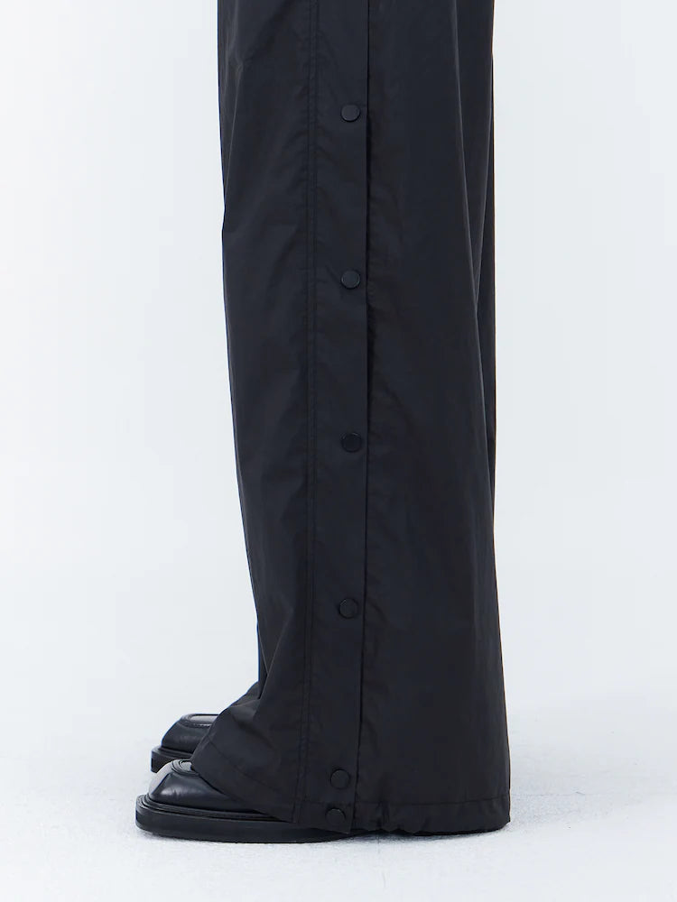 PANTALONES ANCHOS DE ALGODÓN CON BOTONES A PRESIÓN LATERALES Y CÁLIDOS NEGROS